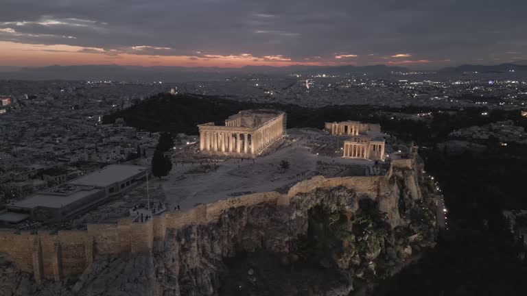 Aerial shots of the illuminated Acropolis of Athens, Greece at night