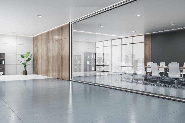 istock Empty concrete floor with place for product presentation in office hall with green plant on light wall background and conference room with city view behind glass partition. 3D rendering, mockup 1492944603