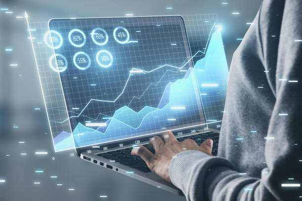 istock Close up of hands using laptop with digital business chart hologram on blurry background. Financial growth and digital report concept. Double exposure. 1492944787