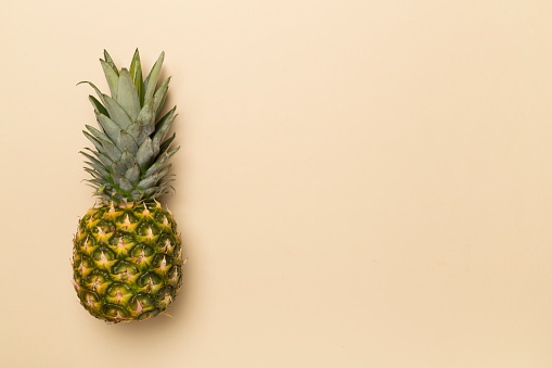 Fresh pineapple on color background, top view