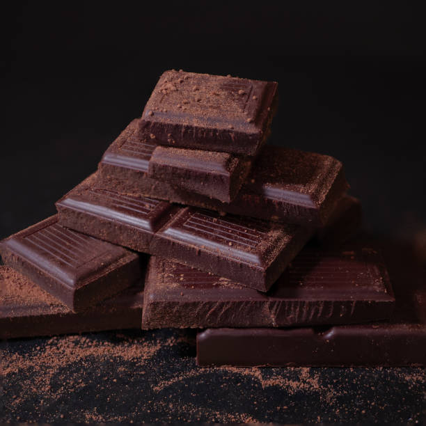 istock Chocolate. Dark Chocolate Bar Stack. Confectionery, Confection Concept. Dark Key Style Sweets with Cocoa Powder 1492953051