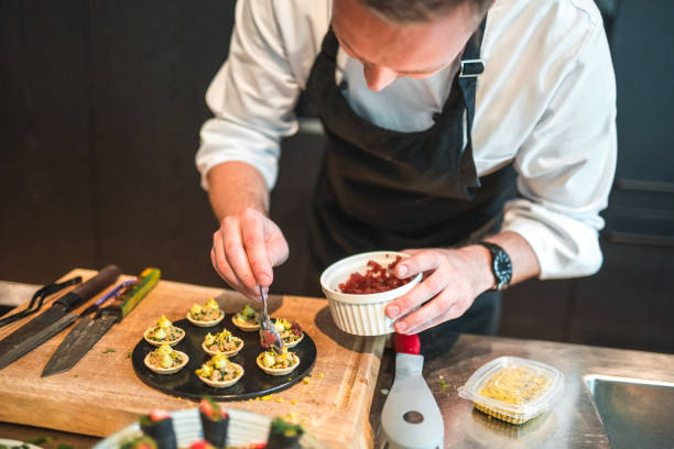 istock Dedicated Young Chef Preparing Gourmet Fare for an Event 1492955719