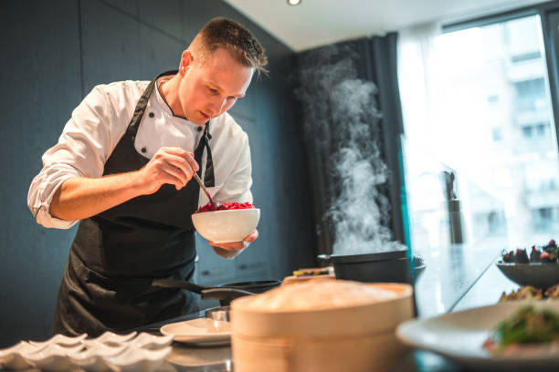 istock Dedicated Young Chef Preparing Gourmet Fare for an Event 1492955772