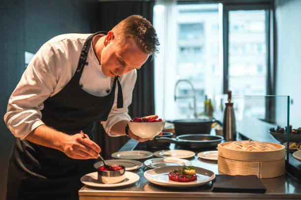 istock Dedicated Young Chef Preparing Gourmet Fare for an Event 1492955781