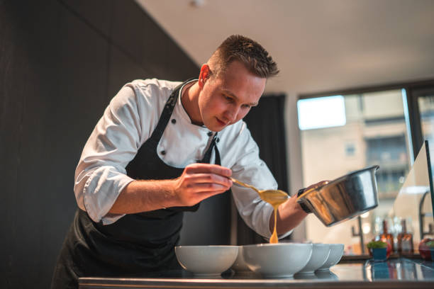 istock Talented Chef Preparing Modern Food Creations for Bachelorette Dinner 1492955922