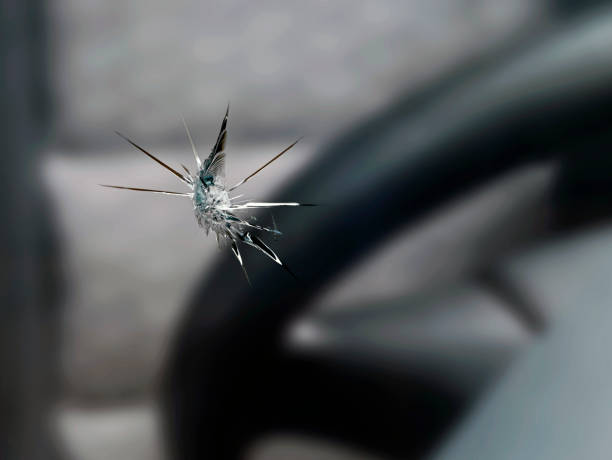 close up of a stone chip in the windshield of a car, detail shot of cracks in car glass on the drivers side close up of a stone chip in the windshield of a car, detail shot of cracks in car glass on the drivers side. sliver stock pictures, royalty-free photos & images