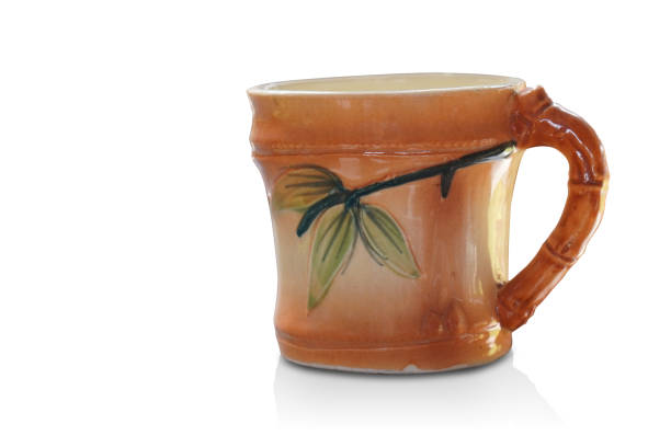 istock side view brown and orange ceramic cup on white background, object, decor, fashion, gift, copy space 1492957723
