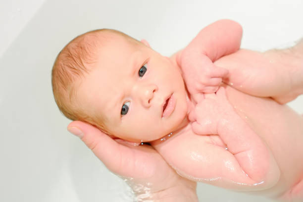 istock A young father bathes his newborn baby. Parenthood. 1492965873
