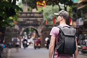 Traveler walking on busy street in Hanoi