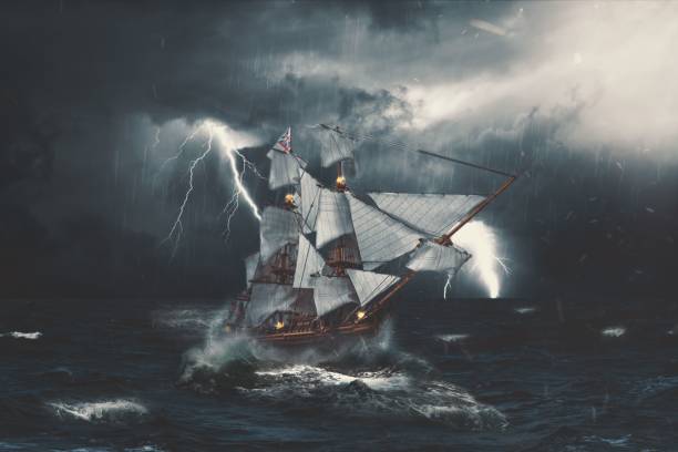 istock a sailing ship in the stormy seas under a storm with clouds and lights on 1492968889