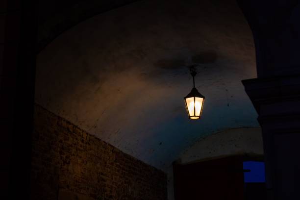 istock a candle light in a stone arch next to brick wall 1492969246