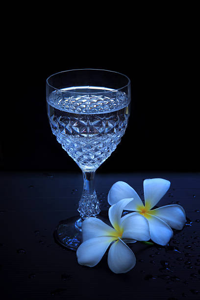 istock wine glasses and white frangipani flowers 149296965