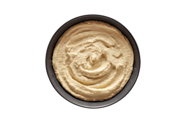 istock Hummus in grey bowl, isolated on white background with clipping path 1492973143
