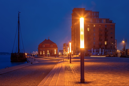 Promenade at the old port in the Hanseatic city of Wismar at the blue hour