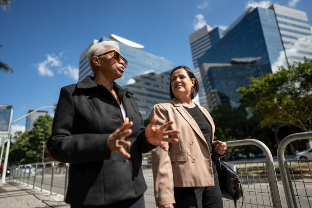 istock Coworkers talking while walking in the street 1492980029