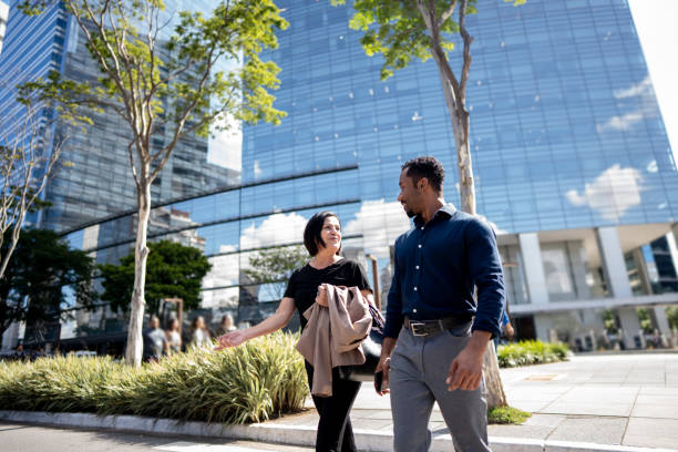 istock Coworkers talking while walking in the street 1492980667