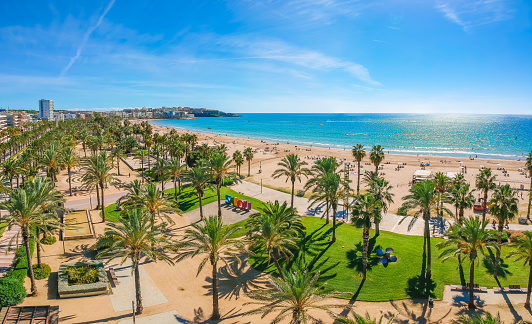 Beach, blue sea and palm trees in Salou city, Catalonia, Spain, Europe