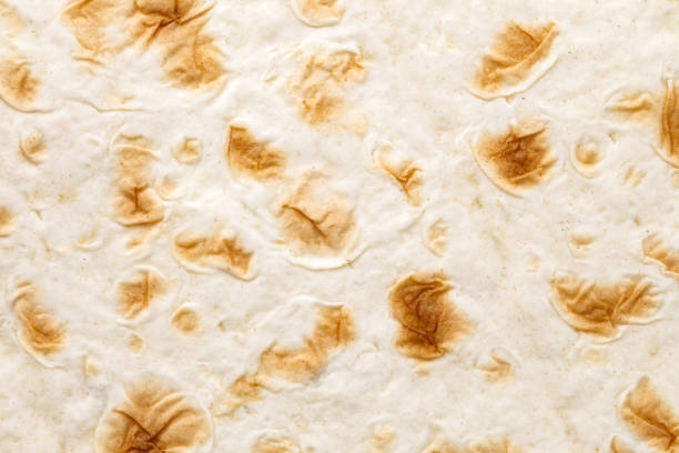 istock Pita tortilla close-up, baked, uniform texture background 1492981113