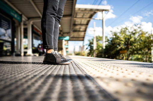 Woman's legs on a train station platform