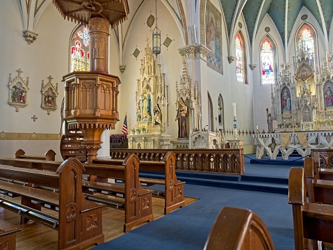 Fredericksburg, TX - USA, April 28, 2023. The alter columns and pews of Saint Mary's Catholic church in Fredericksburg Texas. The newer church on the campus built in 1908 listed on the National Register of Historic Places.