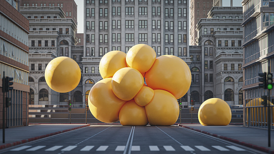A cluster of big soft yellow spheres in the middle of the city street, 3D render