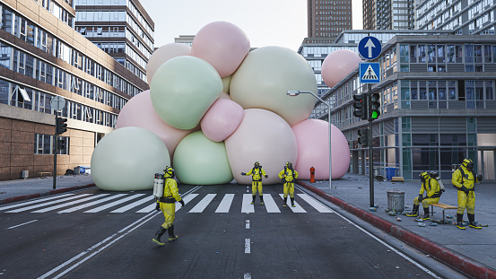 People in protective suits helpless against a cluster of big soft multi colored spheres in the middle of the city street, 3D render
