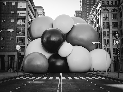 A cluster of big soft spheres stuck in the middle of the city street, 3D render