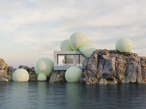 A modern house on a cliff by the sea, covered by green spheres