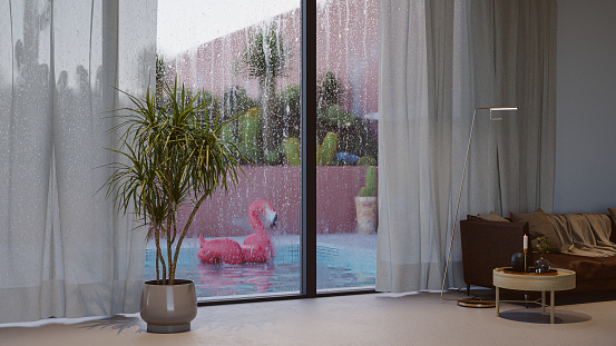 View of the pool area from indoors, raindrops on the window