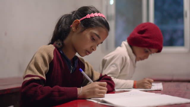 Indian Children of Elementary School Age Studying and Taking Notes in the Classroom, Learning and Education Concept, India