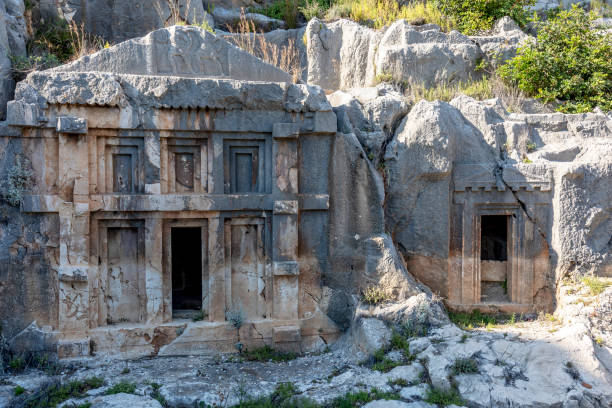 ancient tombs of the kings, in ancient lycian city of myra in demre, antalya province in turkey - antique old fashioned close up color image imagens e fotografias de stock