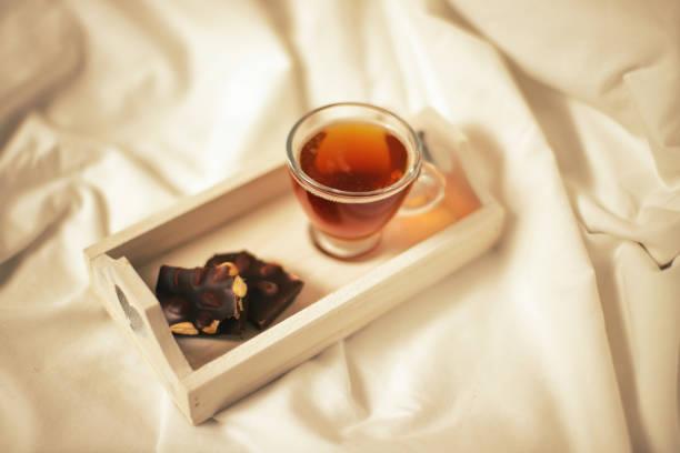 Tea in glass cup in bed, bedroom  breakfast