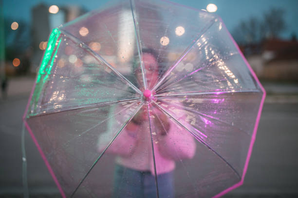 istock An unrecognizable woman opens an umbrella during rainy night 1492993515