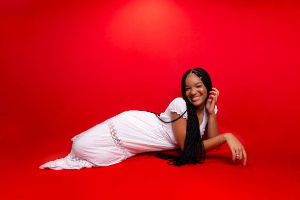 istock Beautiful young black woman sitting down smiling at the camera. 1492993604
