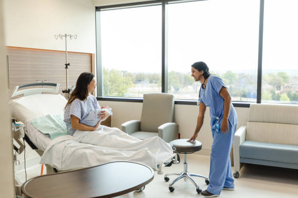 istock Single mom holds new baby while greeting female doctor 1492993664