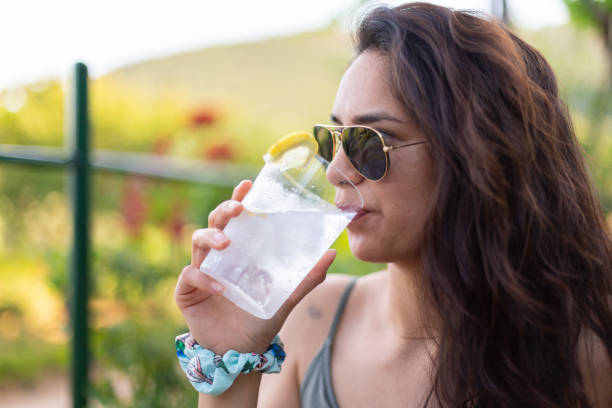 istock Young woman drinking gin and tonic at a party 1492995570