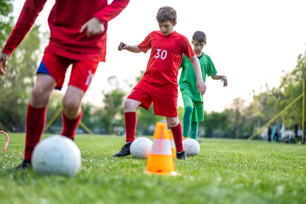 istock boys go around the cones with a ball 1492995584