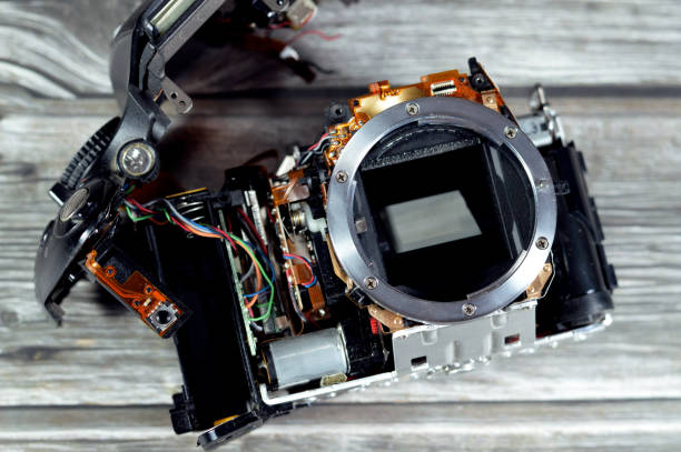 istock DSLR photographic and video digital camera body interior repair by technician or engineer, camera and technology equipment maintenance and repair concept, old SLR crop sensor mirror Camera fixation 1492997285