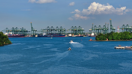 Singapore, Singapore – April 16, 2019: An expansive body of blue water is visible in the frame, in Singapore