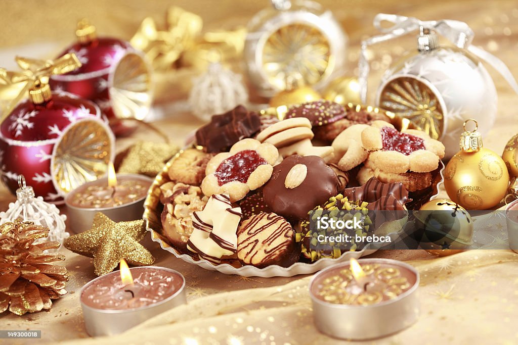 Delicious Christmas cookies Detail of delicious Christmas cookies with candles in golden tone Arrangement Stock Photo