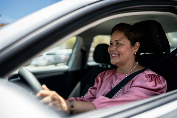 istock Mature woman driving inside a car 1493000820