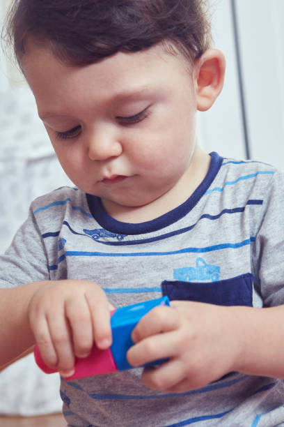 istock Toddler playing with colorful plastic blocks 1493000832