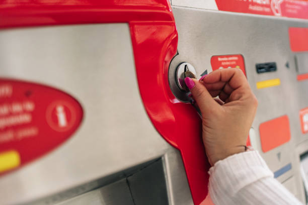 istock Unrecognizable young woman's hand inserting a coin into the ticket vending machine for public transport. 1493000884