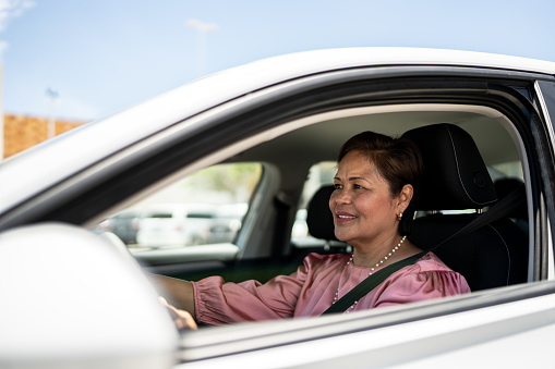 Mature woman driving inside a car