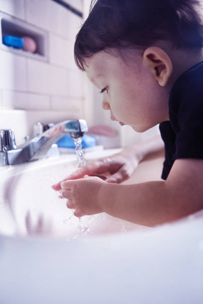 istock Boy washing his hands in bathroom at home 1493001242