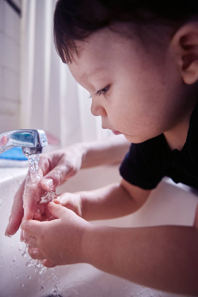 istock Boy washing his hands in bathroom at home 1493001243