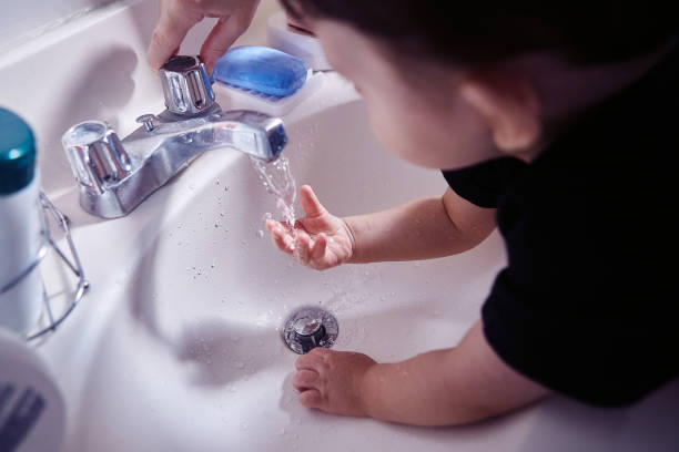 istock Boy washing his hands in bathroom at home 1493001275