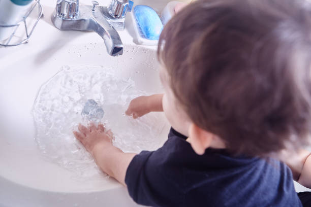 istock Boy washing his hands in bathroom at home 1493001383