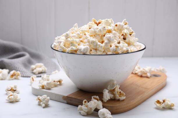 istock Bowl of tasty popcorn on white table 1493003772