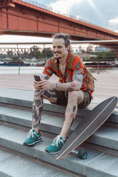 istock Portrait of a young tattooed man using a phone 1493003787